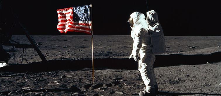 buzz aldrin on the moon with an american flag