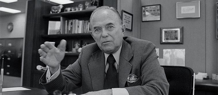 ray kroc sitting at a desk