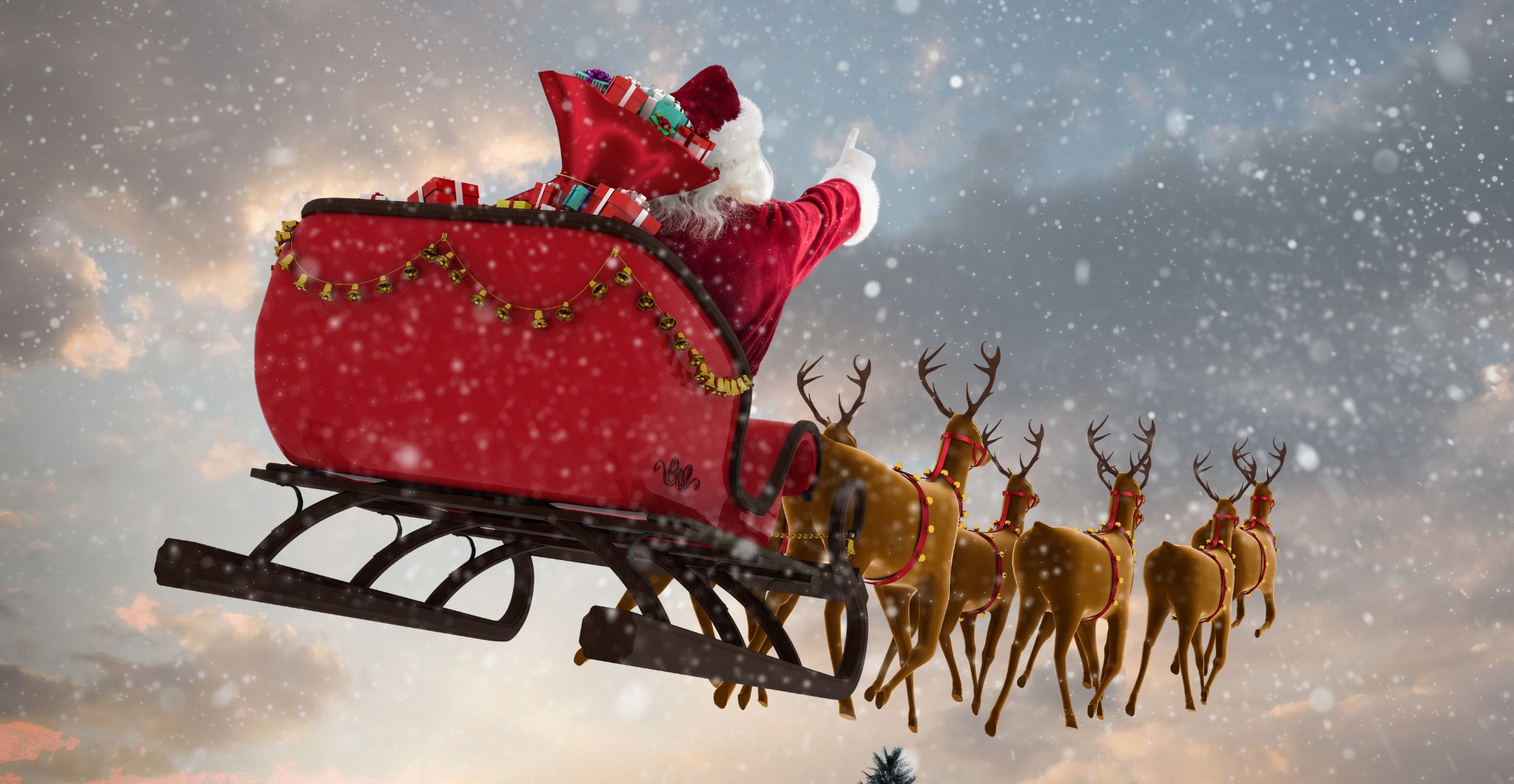 Santa Claus Flying With Reindeer Sleigh And Big Gift Box On Chimney At