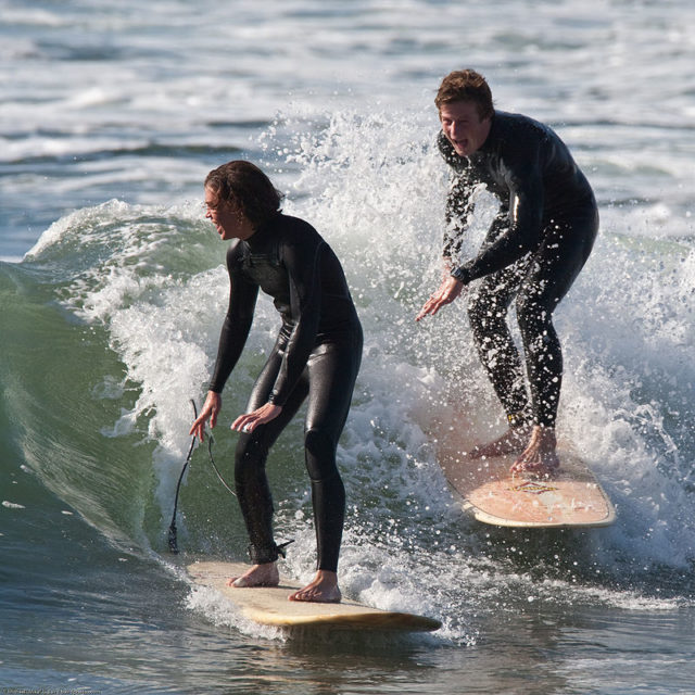 Surfers in steamer wetsuits. Author: “Mike” Michael L. Baird. CC BY 2.0.