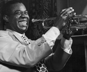 louis armstrong smiling holding trumpet