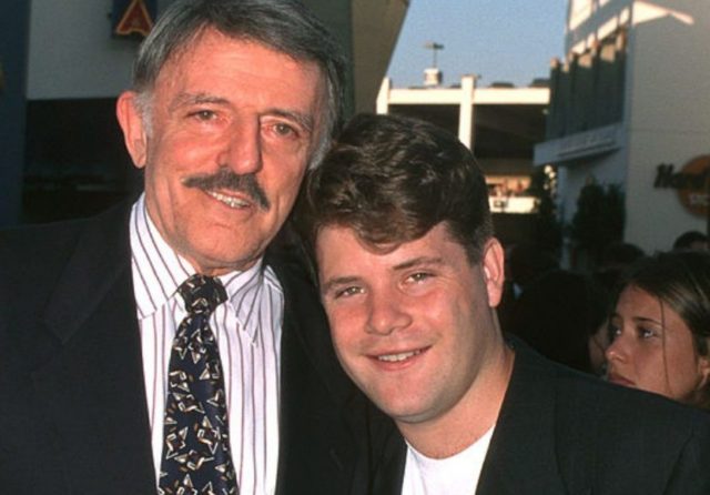 John and Sean Astin standing together on a red carpet