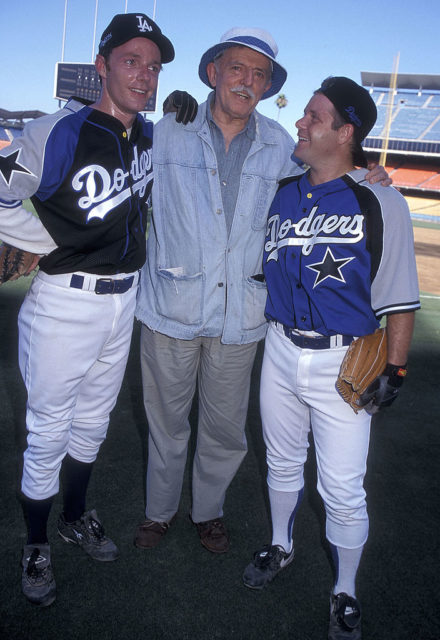 John Astin standing in the middle of Dodger's Stadium with his sons, Mackenzie and Sean