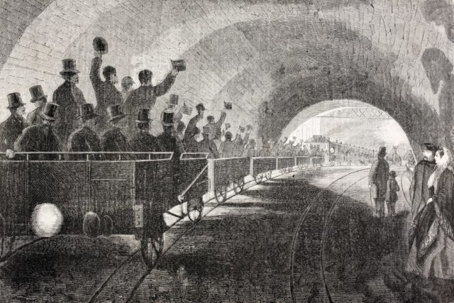 Illustration of people riding a train car in the London Underground