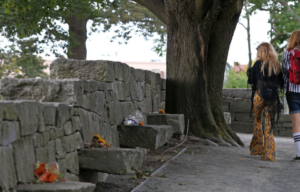 Two women walking along the memorial to the victims of the Salem Witch Trials