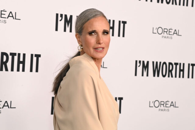 Andie MacDowell standing on a red carpet