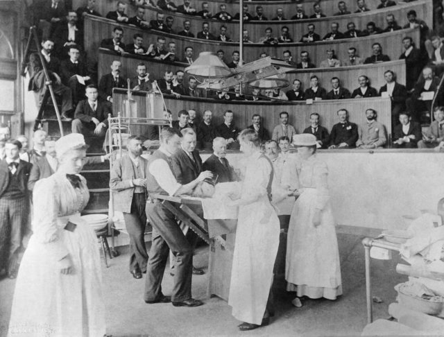 An operating theater, with surgeons and nurses gathered around a table