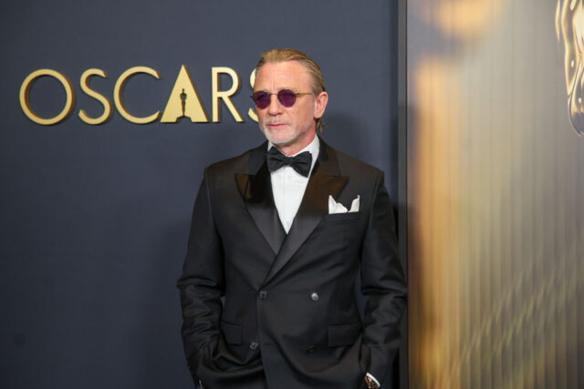 Daniel Craig standing on a red carpet