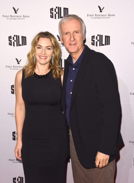 Kate Winslet and James Cameron taking a photo together on a red carpet.