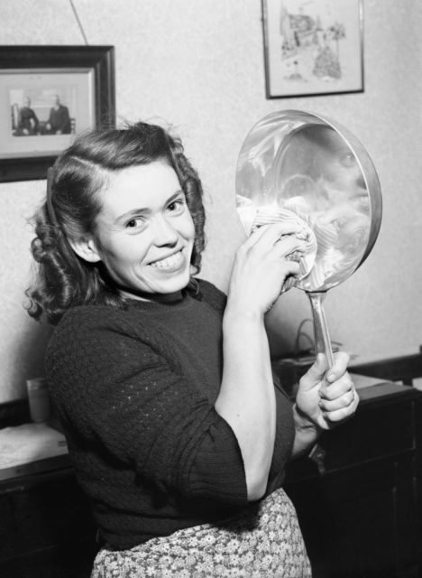 a woman cleans a pan