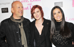 Bruce Willis, Rumer Willis and Demi Moore standing together on a red carpet