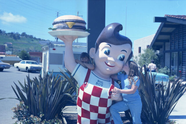 Children standing with a statue at a Big Boy restaurant