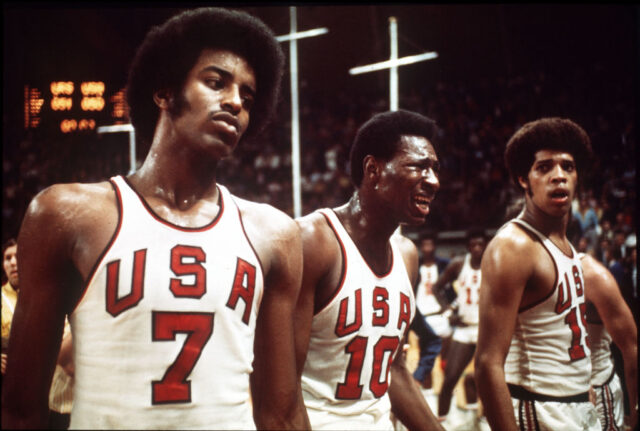 Three players on the US Olympic basketball team looking upset