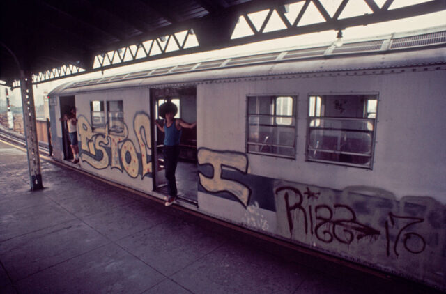 Man standing in the doorway of a a subway car