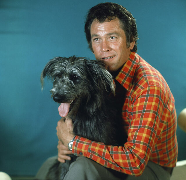 Portrait of Earl Holliman sitting with a dog