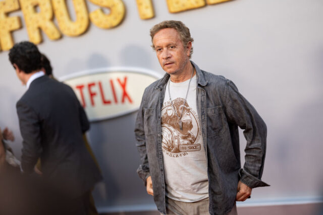 Pauly Shore and other individuals standing on a red carpet