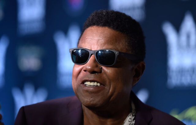 Tito Jackson standing on a red carpet