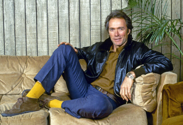 Clint Eastwood sitting on a couch.