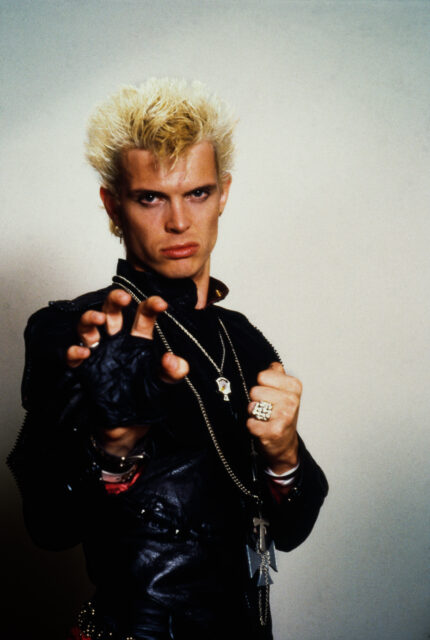 Billy idol holding his hand up.