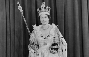 Queen Elizabeth II wearing her crown and holding her ball and sceptre.
