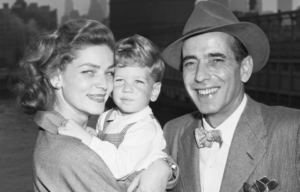 Humphrey Bogart and Lauren Bacall smile with their son, Stephen.
