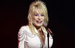 Headshot of Dolly Parton at a microphone.