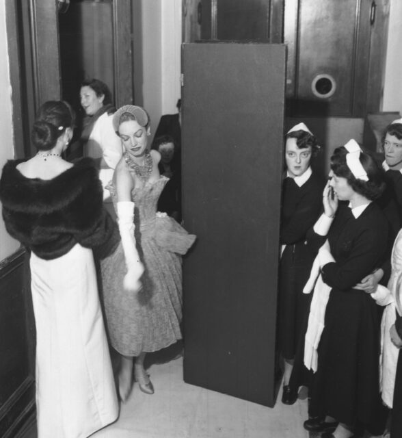 Women standing backstage at one of the 1955 Christian Dior fashion shows