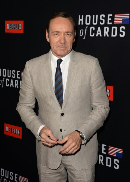Kevin Spacey standing on a red carpet