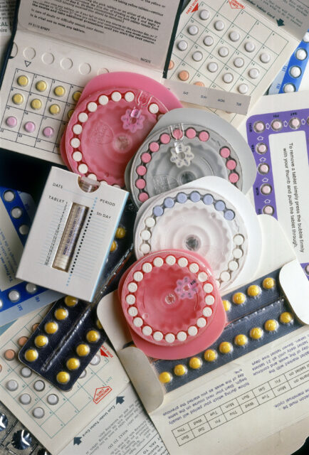 Several birth control packets piled on top of each other.