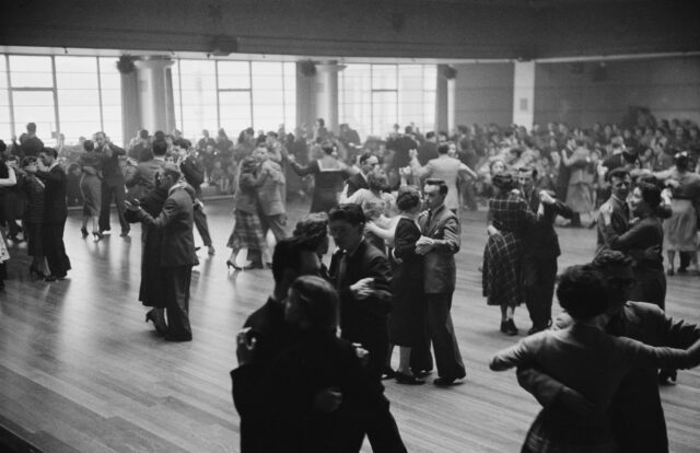 Couples dancing together in a large room