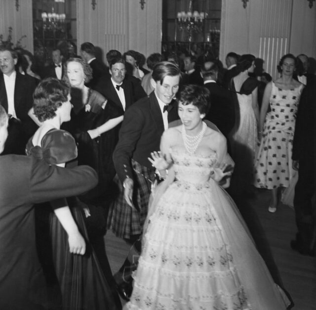 Charity ball attendees standing in a large room