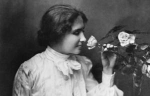 Helen Keller smelling a flower.