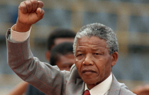 Nelson Mandela holding his fist up.