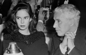 Oona O'Neill and Charlie Chaplin sitting beside one another.