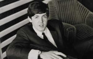 Paul McCartney sitting.