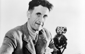 George Orwell in front of a BBC microphone.