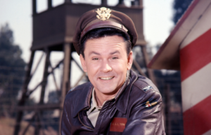 Headshot of Bob Crane with an army hat on.