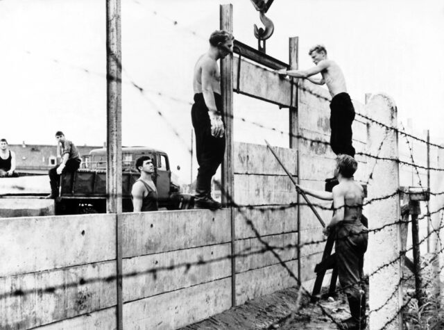 Men constructing the Berlin Wall.