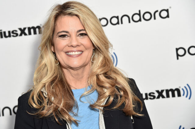 Lisa Whelchel standing on a red carpet