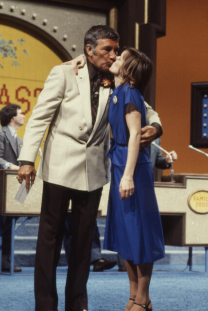 Richard Dawson kissing a female contestant.
