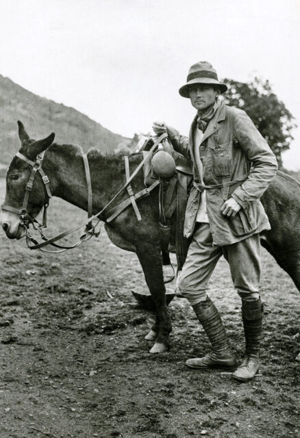 Hiram Bingham beside a horse.