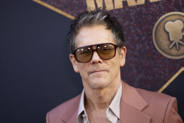 Headshot of Kevin Bacon wearing sunglasses.