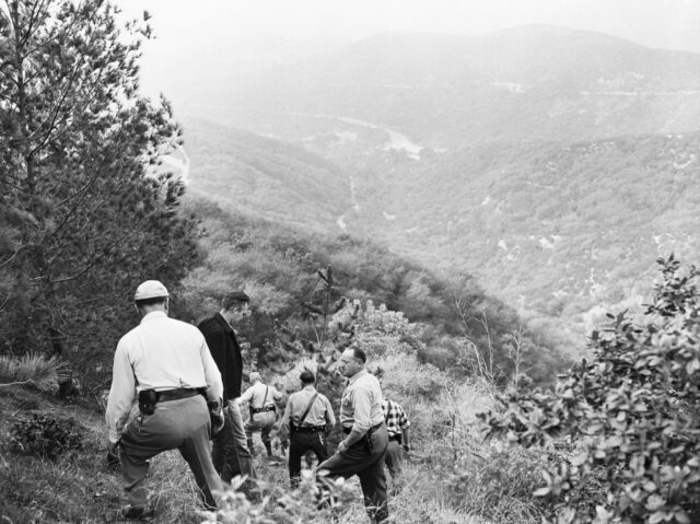 Police officers walking down a steep slope in Griffith Park, Los Angeles, California