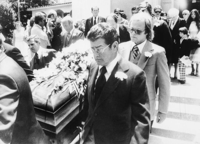 Pallbearers carrying a casket.