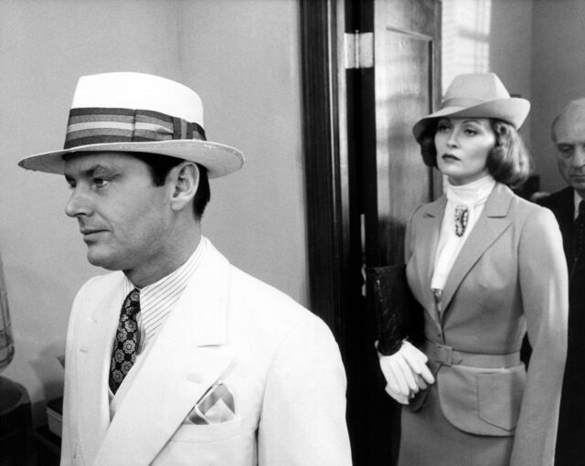 Jack Nicholson walking in front of Faye Dunaway.