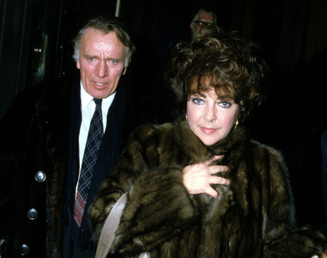 Richard Burton and Elizabeth Taylor walking together.