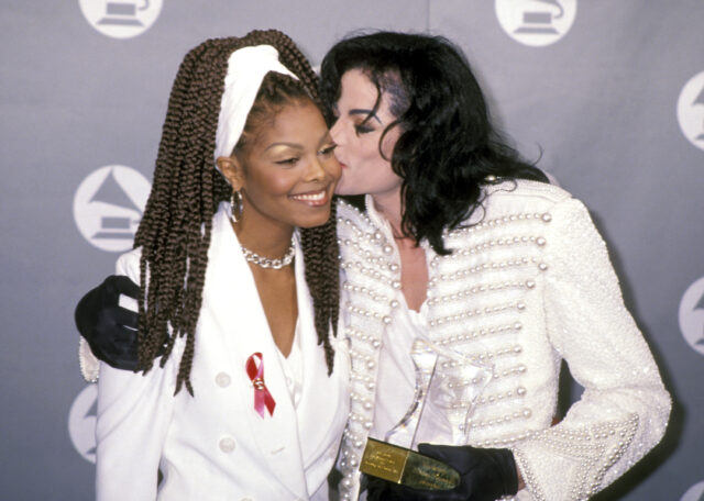 Michael Jackson kissing Janet Jackson's cheek on a red carpet