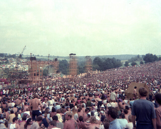 A crowd gathered around stage construction.