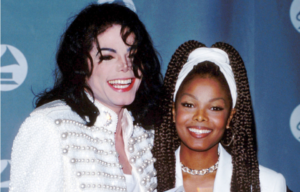 Michael and Janet Jackson standing together on a red carpet
