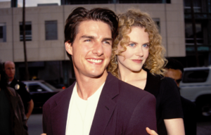 Nicole Kidman standing behind Tom Cruise.